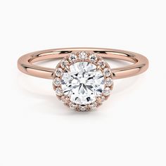 a rose gold engagement ring with an oval diamond center