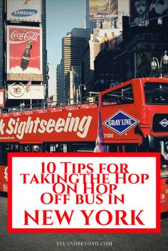 a red double decker bus driving down a street next to tall buildings and billboards