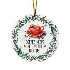 a ceramic ornament with a coffee cup and holly wreath on the bottom that says, coffee keeps me on the nice list