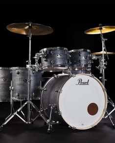 the pearl drum set is shown in black with silver hardware and white drumsticks