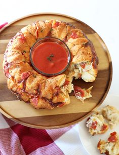 a plate with some food on it and a small bowl of sauce in the middle