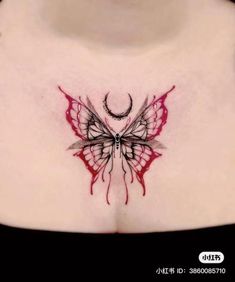 a woman's chest with a red butterfly tattoo on it and the moon in the background