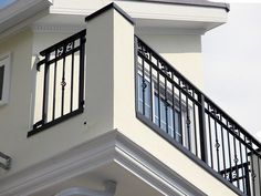 a clock on the side of a building with balcony railings and balconies