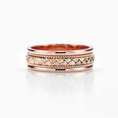 This is a three tone braided wedding band made of solid 10k Gold. This ring comes in rose gold with a yellow, white and pink gold braided center and a solid polished edge with filigree. These bands are light, comfortable and perfectly crafted with Comfort Fit.  D E T A I L S: * Made in Canada * Material: 10k Gold * Finish: Brushed/Polished * Comfort Fit * Width: 6mm * Thickness: 1.4mm * Interior engraving available upon request * Processing time 7-10 business days  VERY IMPORTANT  These bands are made to order for your specific ring size. We STRONGLY urge all our clients to double check your ring size before ordering. 1/4 and 1/2 size adjustments can be made at no extra cost ( shipping at your expense ) In the event that the band is a full size ( or more ) too big or too small, a new band Braided Wedding Band, Wedding Band Gold, Rose Gold Wedding Band, Rose Gold Wedding Bands, New Bands, Rose Gold Wedding, Gold Wedding Band, 10k Gold, Tri Color