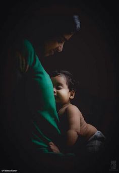 a woman holding a baby in her arms