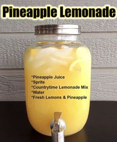 a glass jar filled with lemonade sitting on top of a table