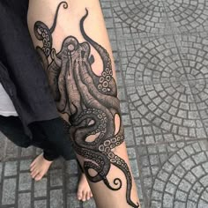 an octopus tattoo on the arm and leg