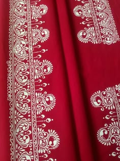 a red cloth with white designs on it