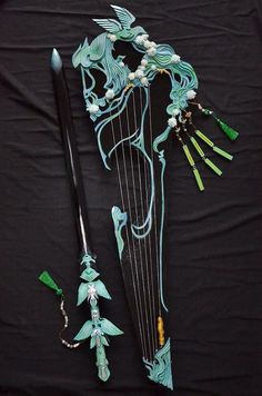 an elaborately decorated harp and some other items on a black background