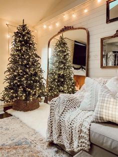 a living room filled with furniture and christmas trees