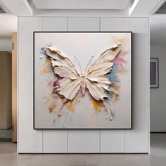 a large butterfly is hanging on the wall in an empty room with tile flooring