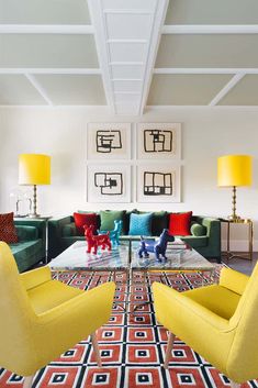 a living room filled with lots of furniture next to lamps and pictures on the wall