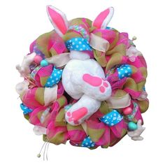 a pink and green wreath with a bunny on it