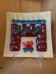 a glass plate with candles and decorations on it