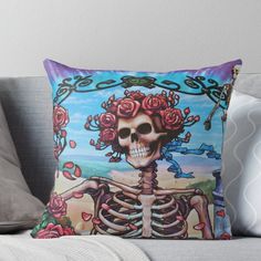 a skeleton with roses on its head sitting on a couch