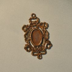 an ornately decorated brooch hangs on the wall