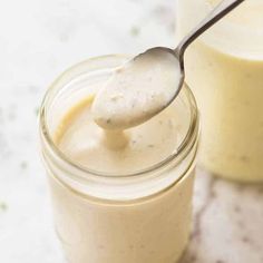 a spoon in a jar filled with cream