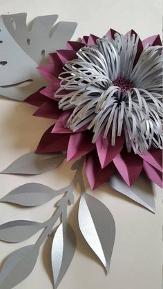 the paper flowers are cut out and placed on the table