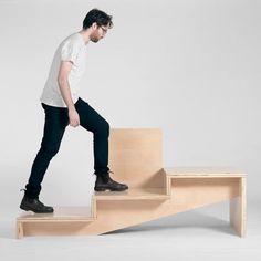 a man standing on top of a wooden stair case