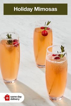 three glasses filled with drinks sitting on top of a white marble counter next to each other