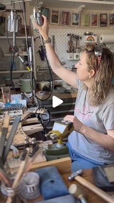 a woman is working on something in her workshop