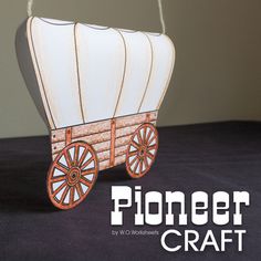 an ornament shaped like a wagon with wheels and spokes attached to it