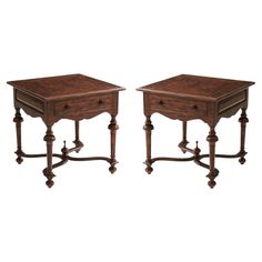 a pair of end tables with turned legs and carved wood tops, each side by side