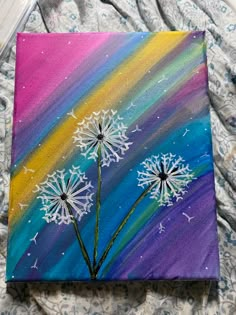 a painting of three dandelions on a colorful background