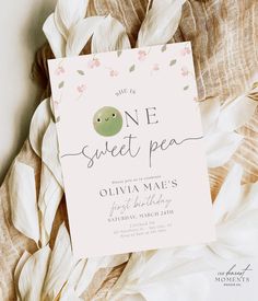 a baby shower party is set up on top of some white flowers and leaves with the words, one sweet pea