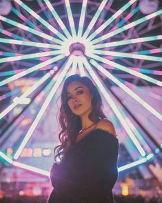 a woman standing in front of a ferris wheel with the caption's name below it