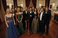 a group of people standing next to each other in formal wear