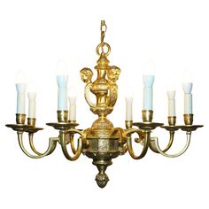 an antique chandelier with six candles on it