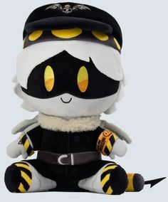 a stuffed animal with yellow eyes and black hat sitting on the ground next to a white background