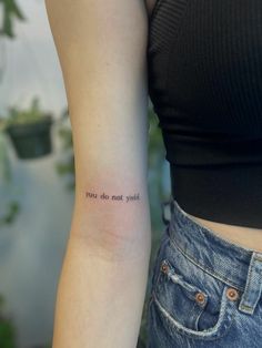 a woman with a small tattoo on her arm