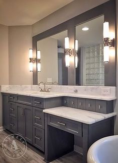 a large bathroom with two sinks and a bathtub in the middle of the room