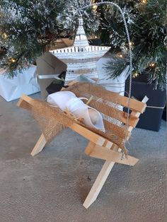 a wooden sleigh sitting in front of a christmas tree