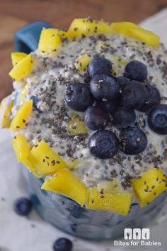 a blueberry and mango smoothie in a glass bowl