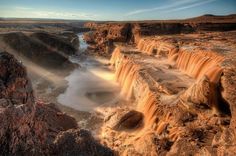 the water is flowing over the rocks and into the river bed in the canyons