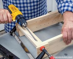 a man working with tools on a piece of wood