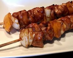 the skewers are covered with meat and onions