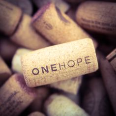 a cork with the word one hope written on it surrounded by other wine corks