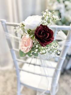 a bouquet of flowers sitting on top of a white chair