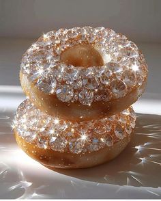 two donuts covered in diamonds sitting on top of each other