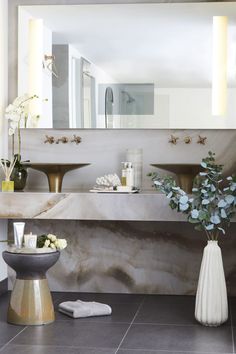 a bathroom with marble counter tops and two sinks