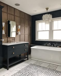 a bath room with a tub a sink and a mirror on the wall next to a window