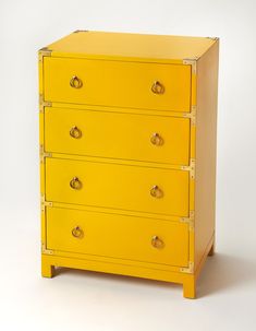 a bright yellow chest of drawers with brass hardware on the top and bottom, against a white background