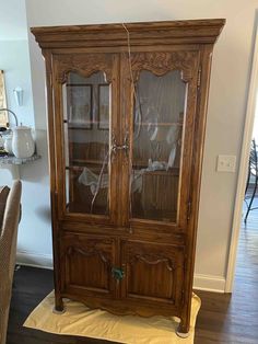 an old wooden china cabinet with glass doors