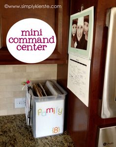 a refrigerator freezer sitting inside of a kitchen next to a sign that says mini command center