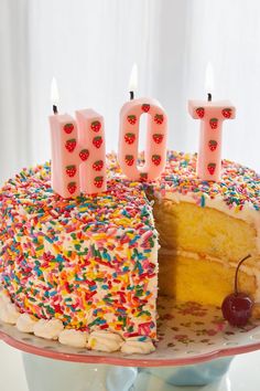 a birthday cake with the number 10 on it and lit candles in front of it