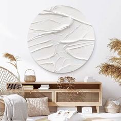 a living room with white walls and wicker furniture on the floor, including a round mirror